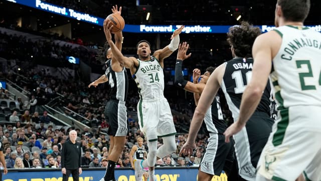 Jan 4, 2024; San Antonio, Texas, USA; Milwaukee Bucks forward Giannis Antetokounmpo (34) between San Antonio Spurs forward Dom Barlow (26) and guard Devin Vassell (24) during the first half at Frost Bank Center.